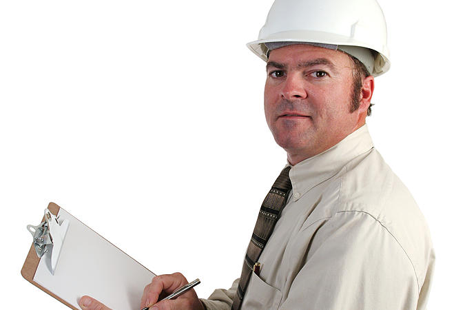 Engineer writing on clipboard